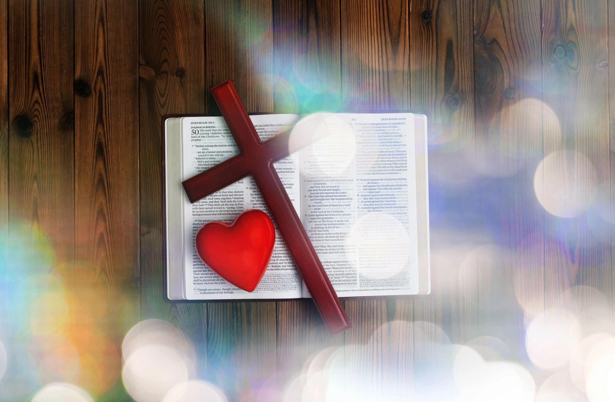 Bible and cross on wooden table